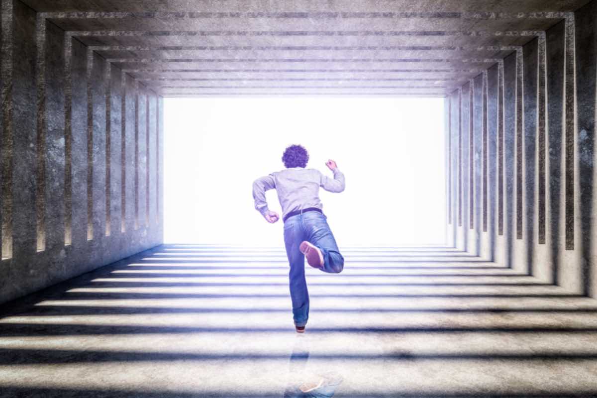 Uomo corre verso l’uscita del tunnel