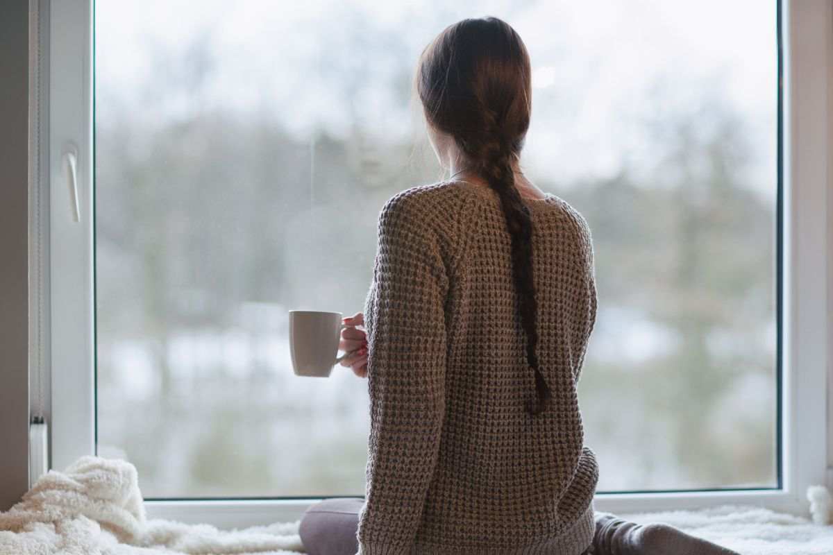 Ragazza si rilassa ammirando dalla finestra